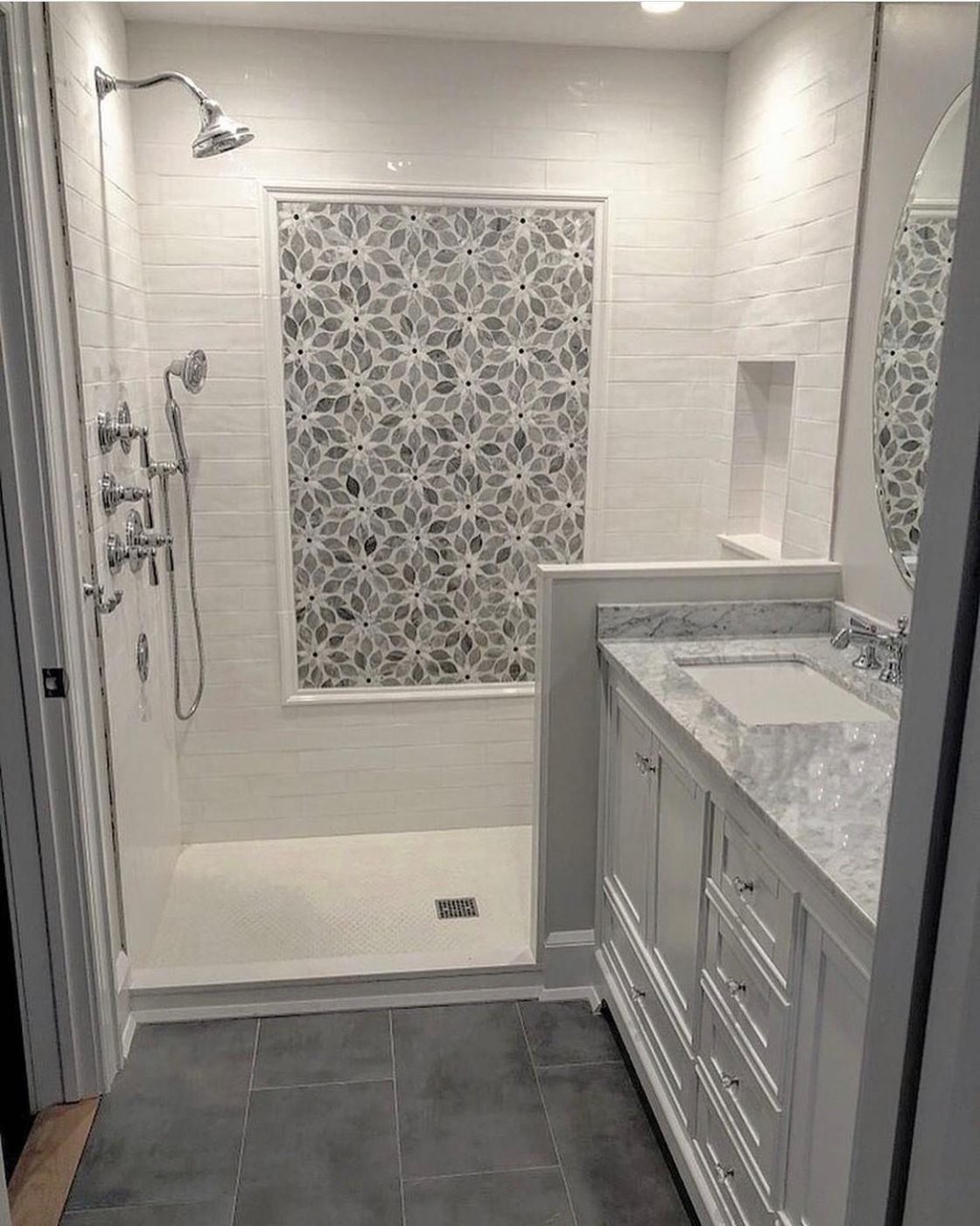 Marble bathroom with mosaic tile shower feature wall