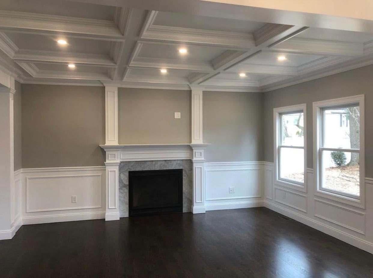 Living room with coffered ceiling and marble fireplace surround