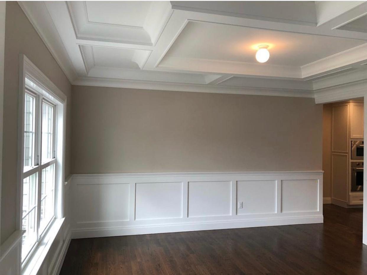 Dining room with wainscoting and coffered ceiling detail