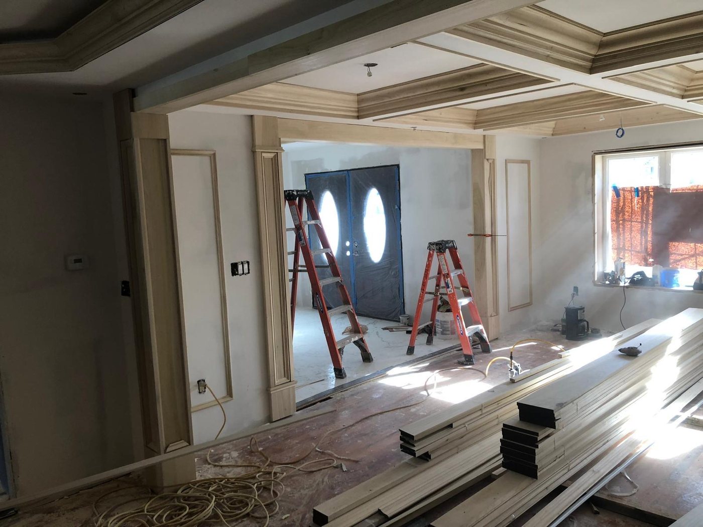 Custom millwork and coffered ceiling installation in progress