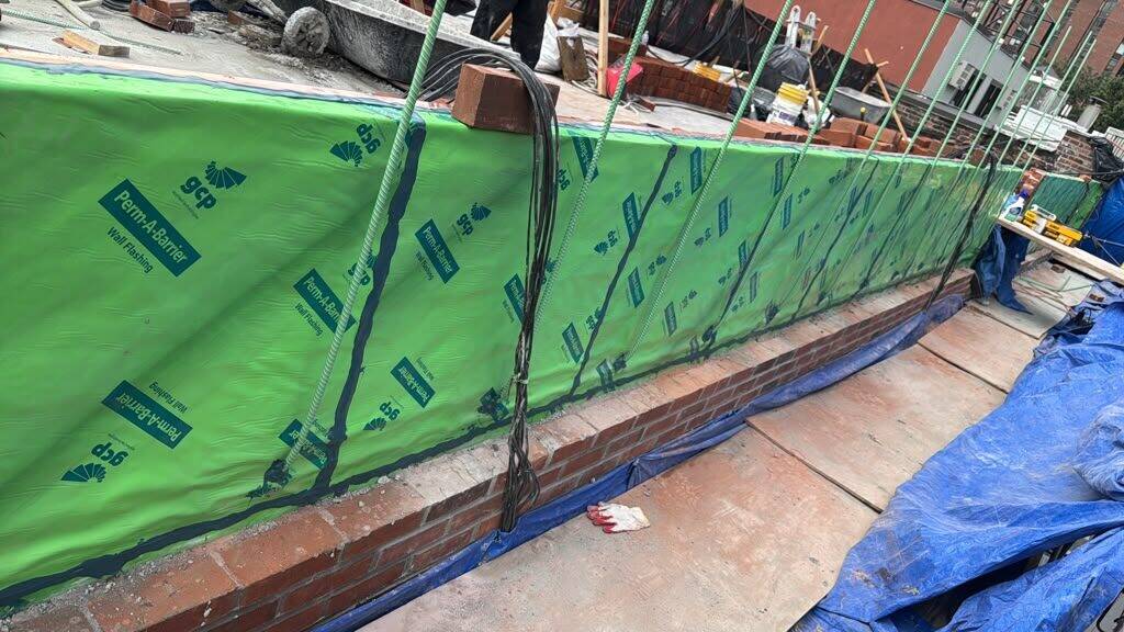 Building envelope waterproofing work on a roof
