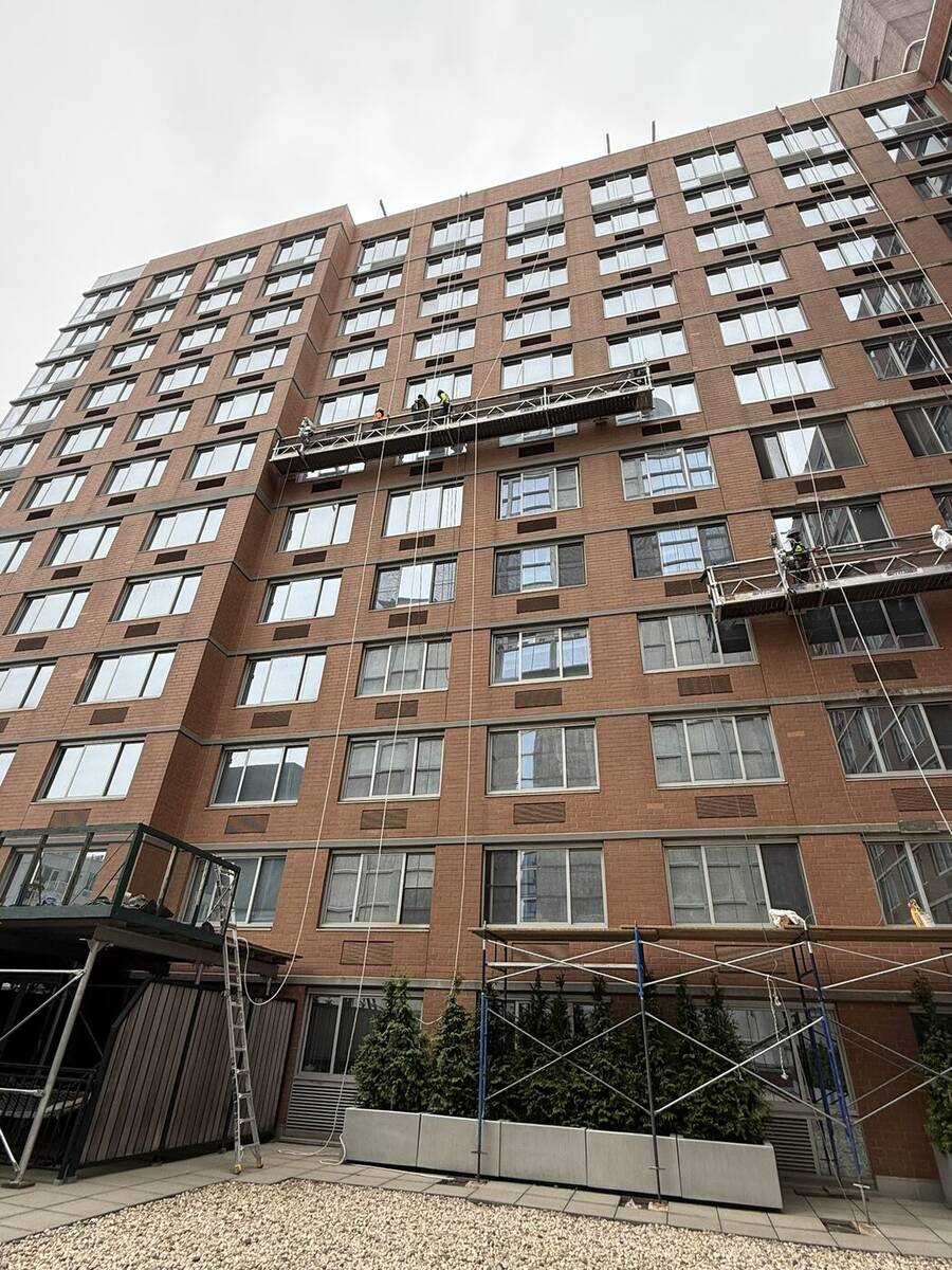 Scaffold bracing secured to a building exterior